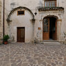 The Court of S. Maria of the Virgins and stone portal and a door in carved wood