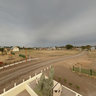 Pole aerial panorama - street through railways and Inmigrants Square